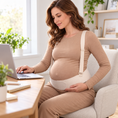 Load image into Gallery viewer, Model wearing the SUNVENO YP04 beige maternity support belt with adjustable shoulder straps while seated at a home office desk

